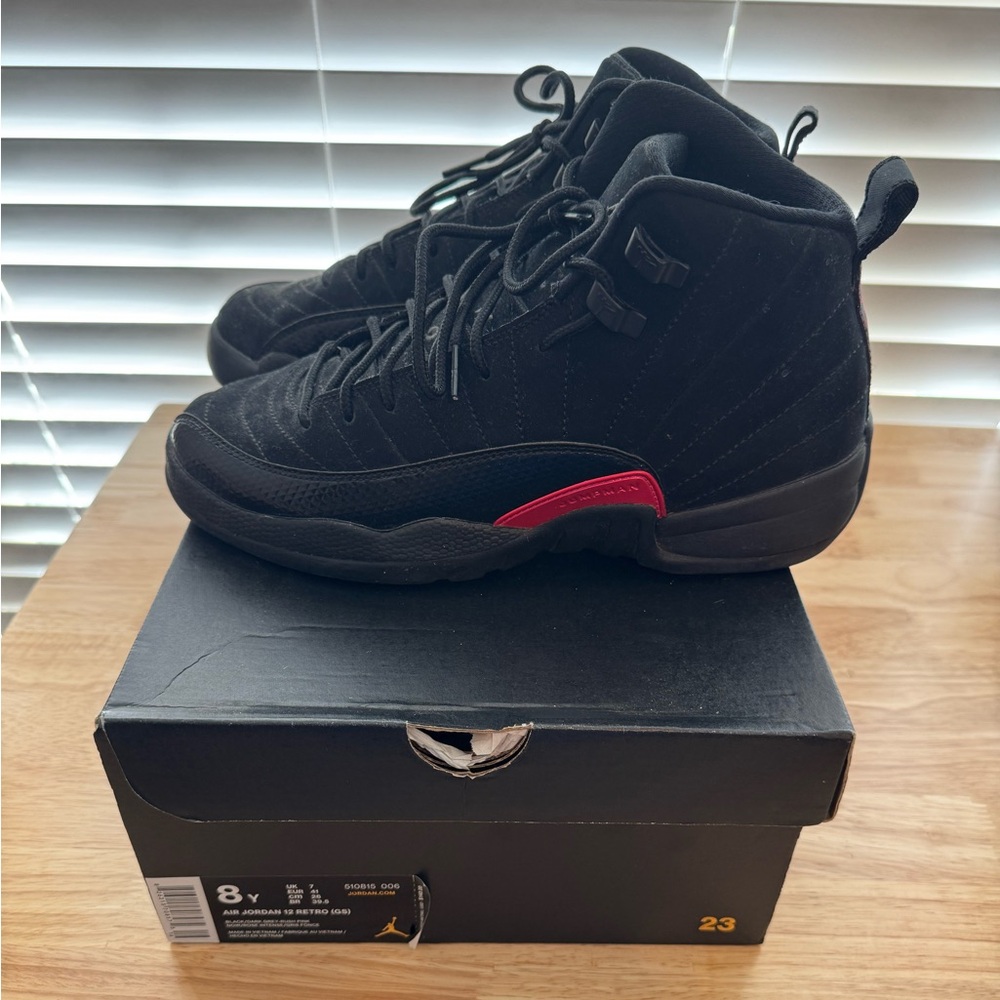 The Jordan 12 Retro Black Rush Pink. Size 8Y. Crease protectors included